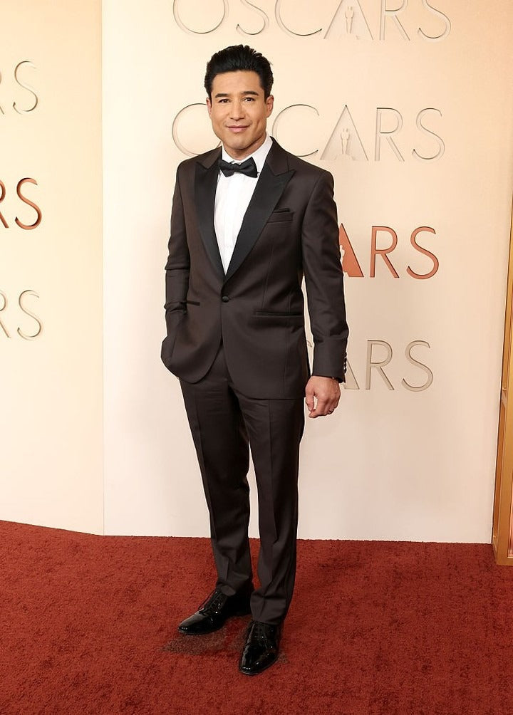 Access Hollywood’s @mariolopez at the 98th Annual Oscars wearing a custom wool tuxedo in deep espresso with black satin peak lapels, paired with a concealed placket evening shirt.